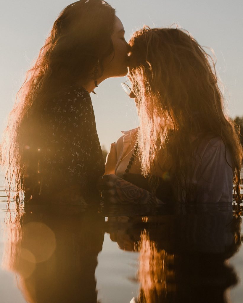 lgbtq couple in water for sunset session by ontario photographer heather doughty photography