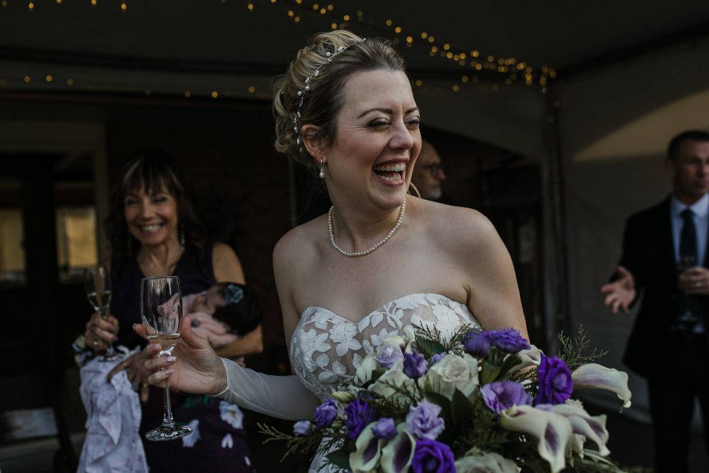 wedding couple and their family walking up the driveway at their winter home wedding