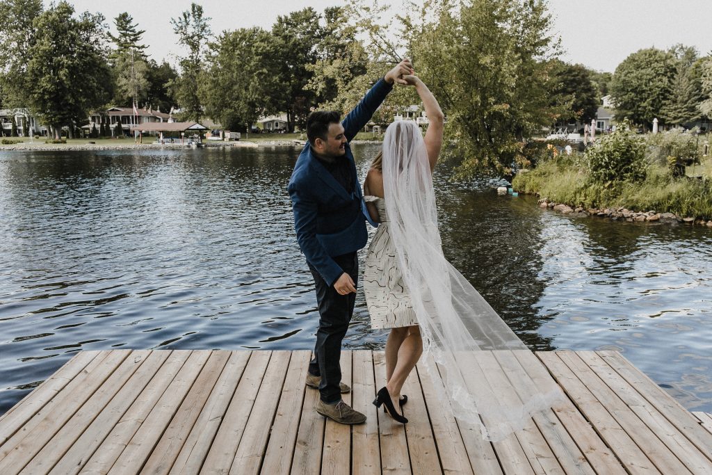wedding couple dancing on the dock at their elopement wedding at a cottage