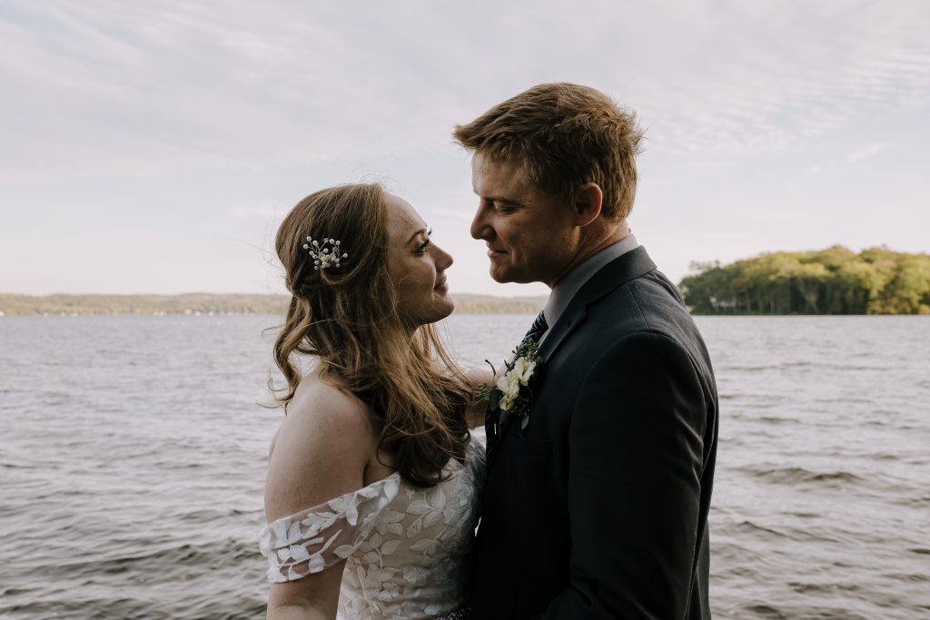 intimate portrait of bride and groom at wedding on the lake in cottage country